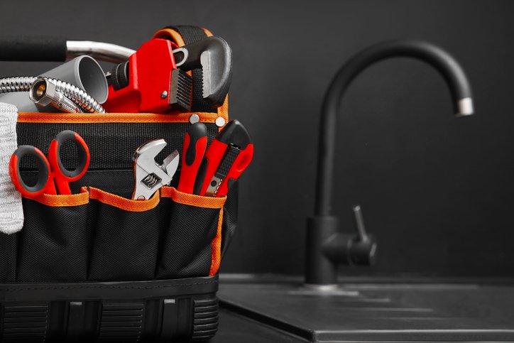 Bag with tools near kitchen sink