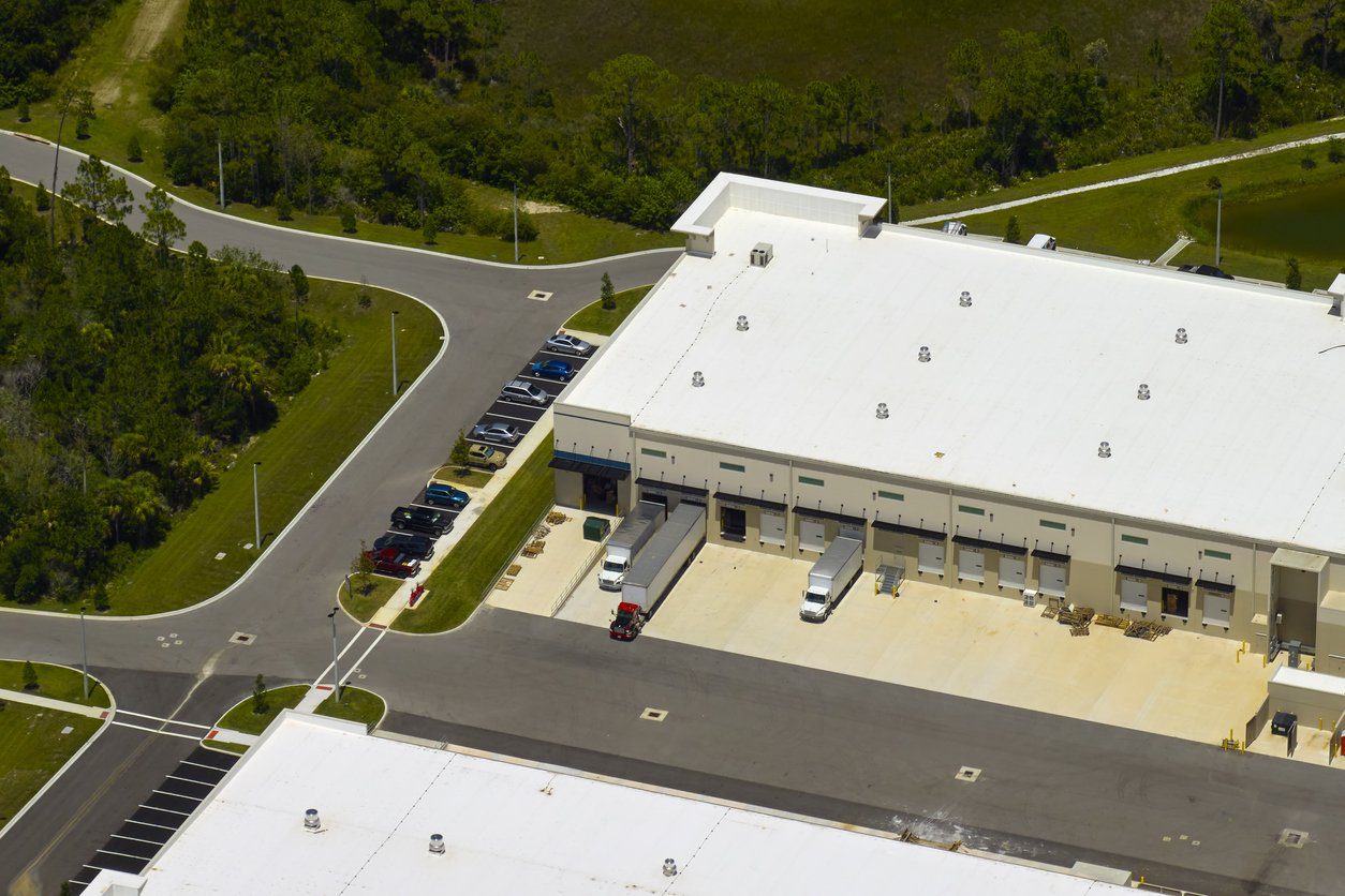 Aerial view of industrial park with goods warehouses and logistics centers in city zone from above